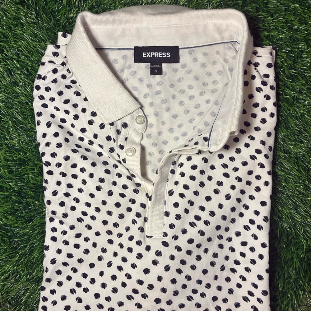 Express Ivory and navy dot pattern with wicking technology to keep you dry.
